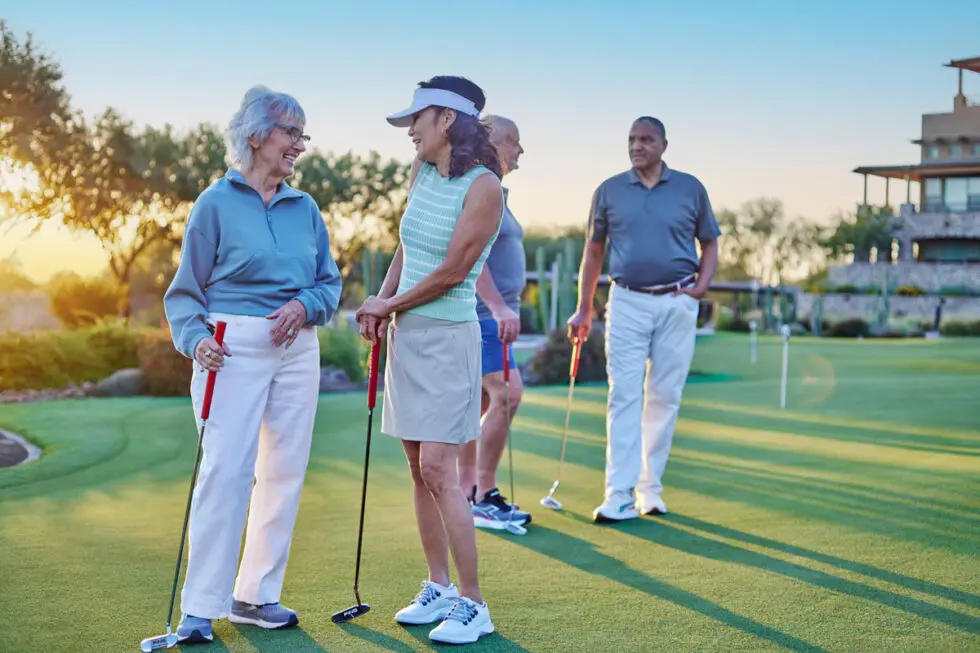 Residents enjoying a day of golfing together outdoors
