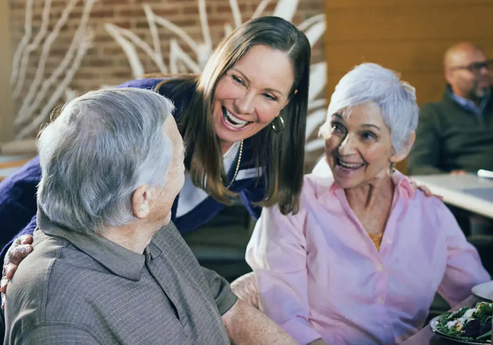 Staff interacting with residents in a dining area