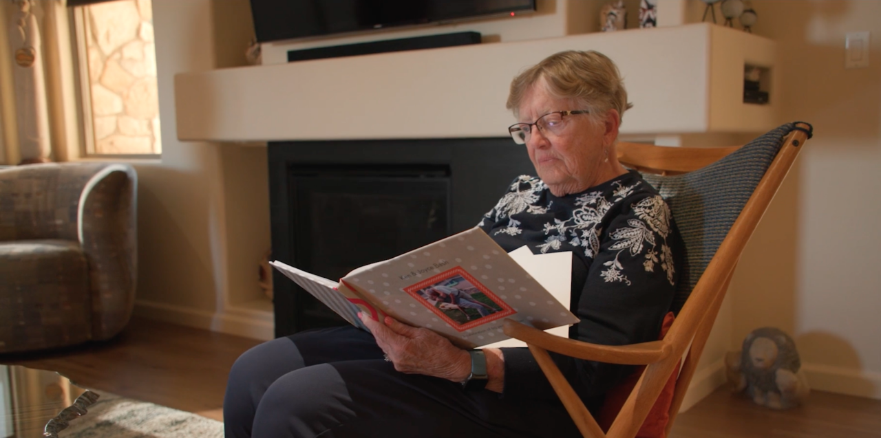 Senior woman reading an album in a cozy chair