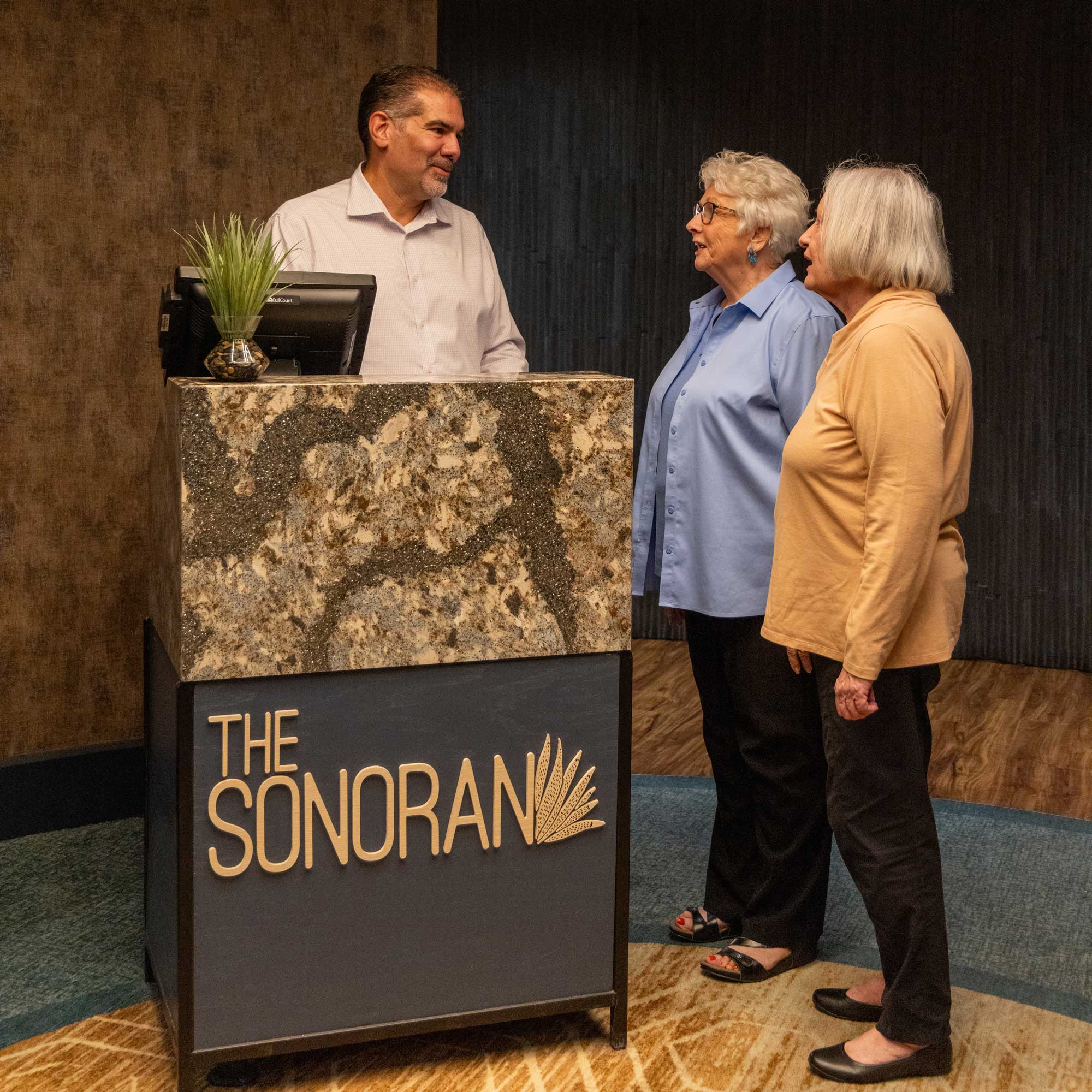 Staff assisting residents at the reception area