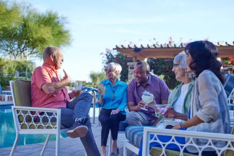 Residents enjoying a conversation by the poolside