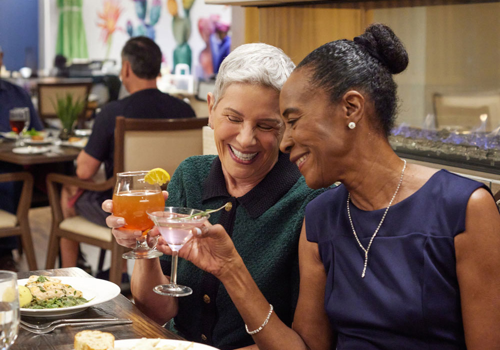 Two residents enjoying drinks and dinner together