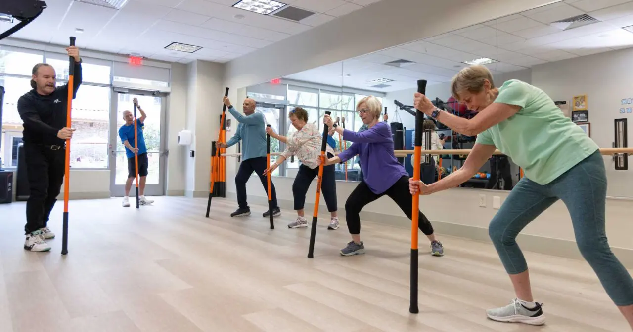 Residents participating in an exercise class with poles