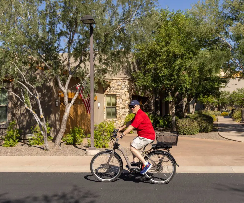Resident riding a bicycle in the outdoor area