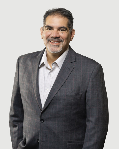 Professional portrait of a smiling man in a suit