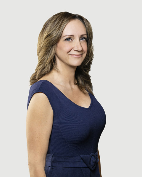 A woman smiling in a studio setting