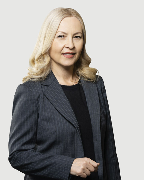 Professional woman in a blazer with a neutral background