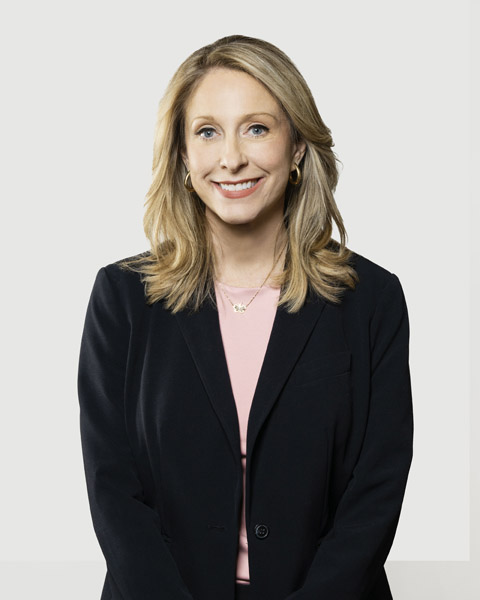 Professional portrait of a smiling woman in formal attire