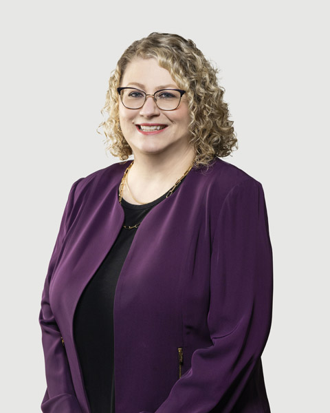Professional portrait of a staff member in a purple jacket