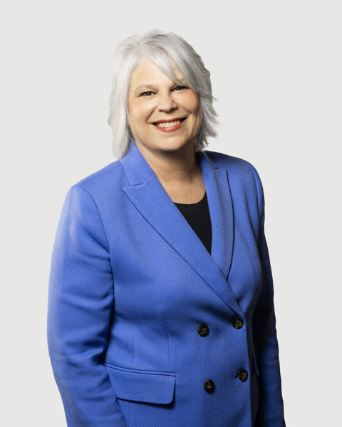 Professional woman smiling in a blue blazer