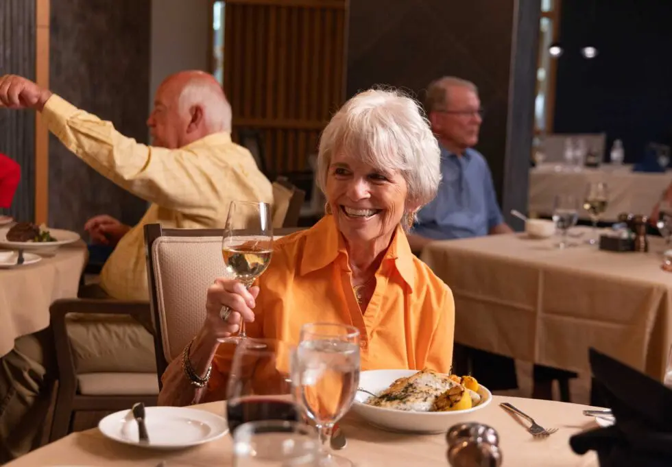 A resident enjoying a meal in the dining room.