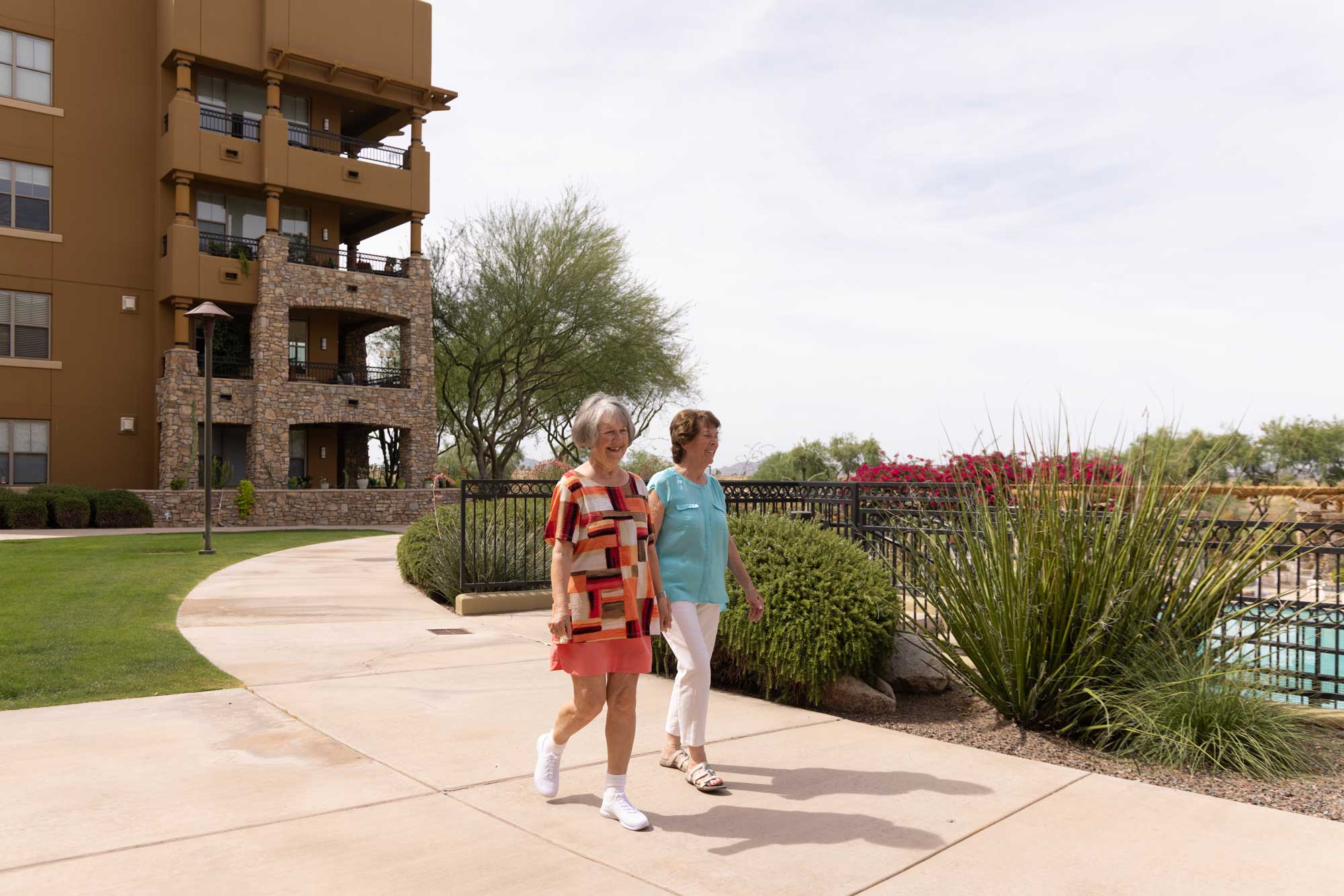 Residents walking along a pathway near the facility
