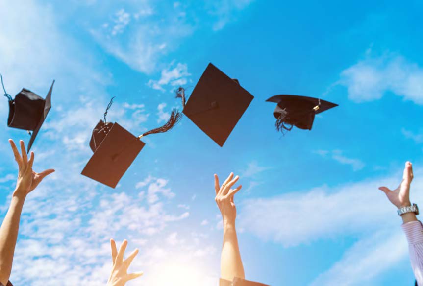 Graduation caps being thrown into the air