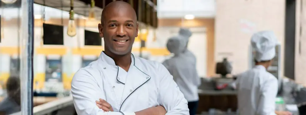 Chef smiling in a kitchen environment