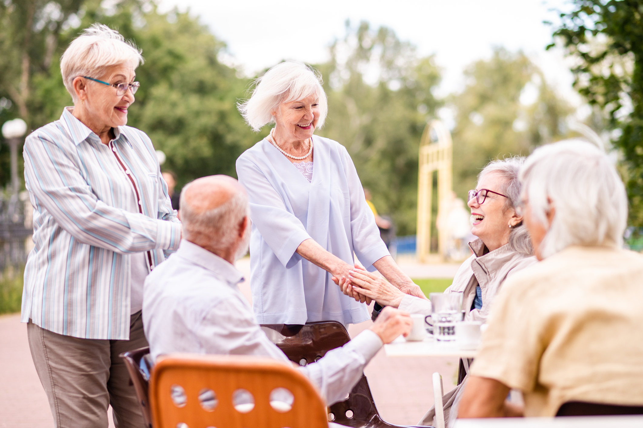 Seniors engaging in conversation outdoors