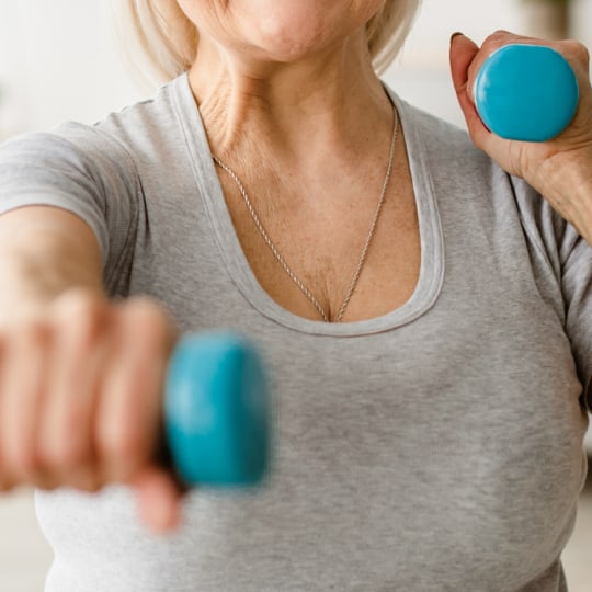 Senior woman exercising with dumbbells