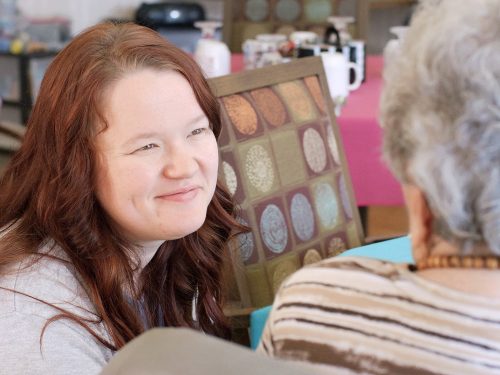 Resident and staff member having a conversation.