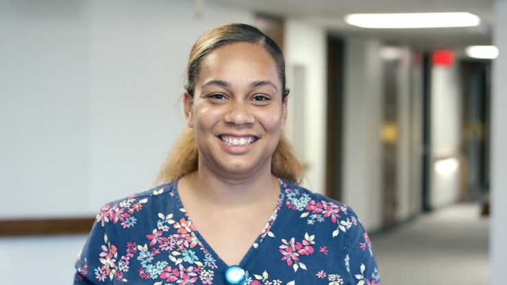 Staff member smiling in a hallway