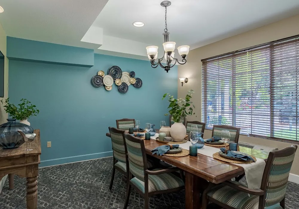 Dining area with a wooden table and blue decor