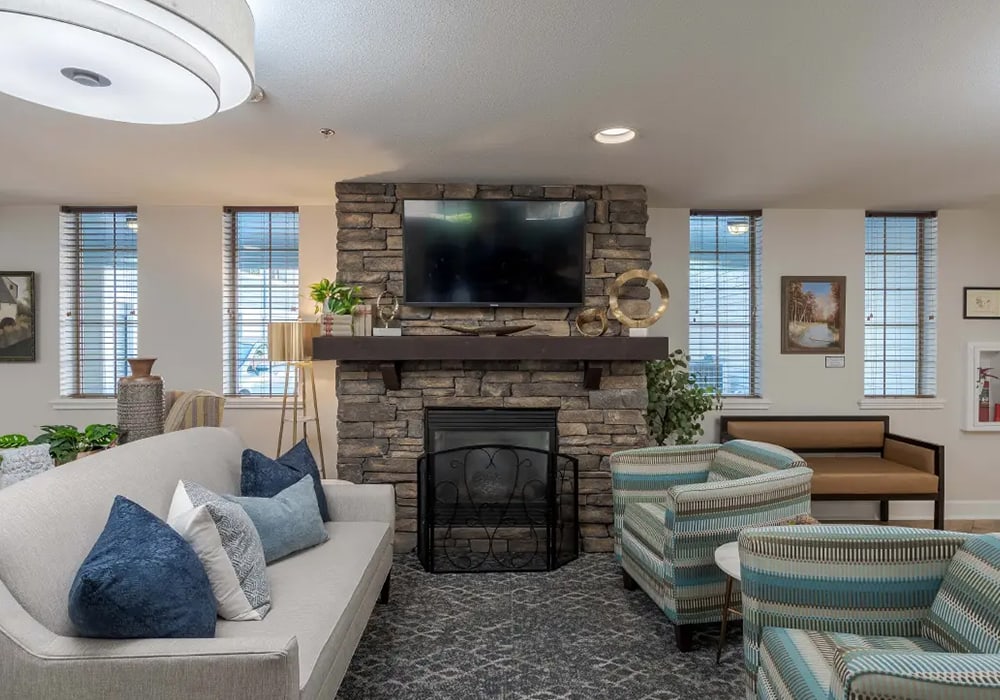 Cozy common area with fireplace and seating.