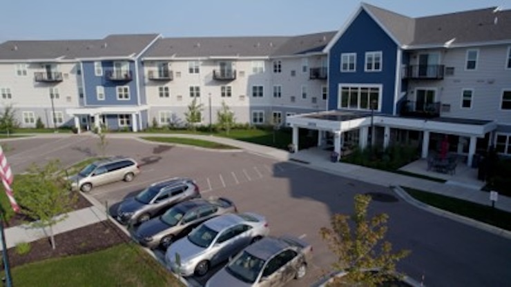 Exterior view of the assisted living facility with parking area.