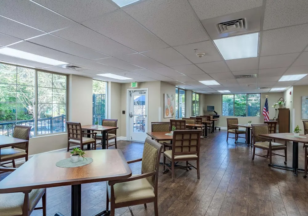 Bright dining area with tables and chairs.