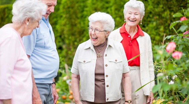 Residents enjoying a garden together with smiles.