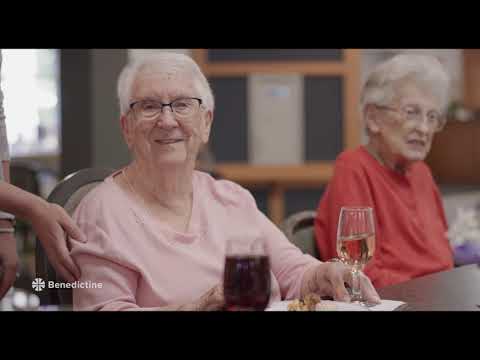 Seniors enjoying drinks and conversation in a common area.