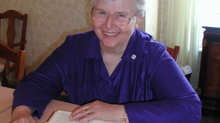 Smiling elderly woman enjoying her time indoors.