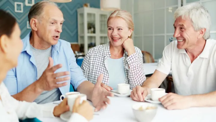 Seniors engaging in conversation over coffee