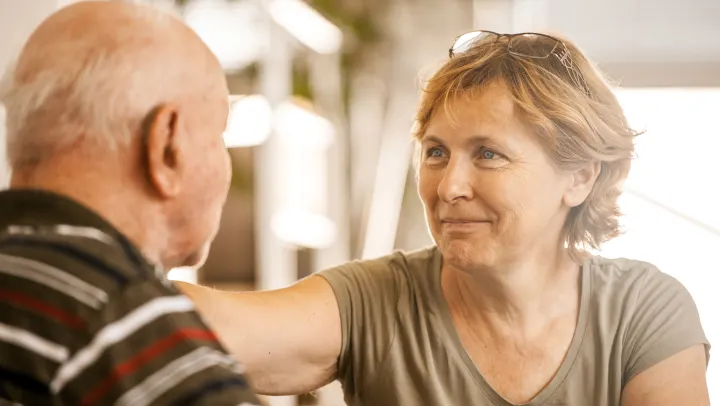 Caregiver interacting warmly with a resident.
