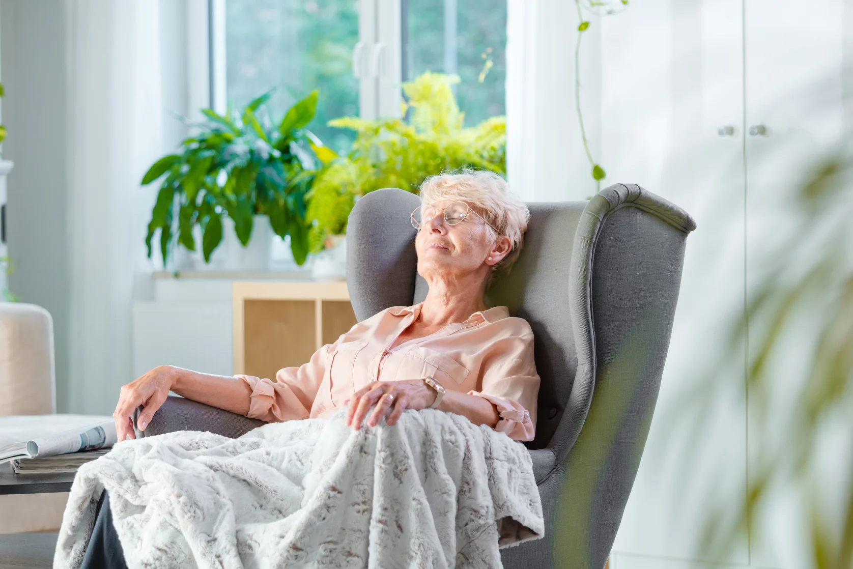 Senior woman relaxing in a cozy chair.