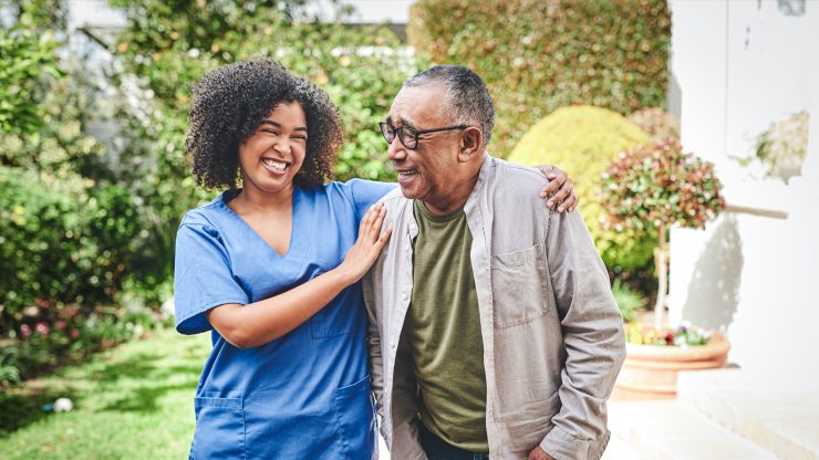 A caregiver and a resident enjoying time outside.