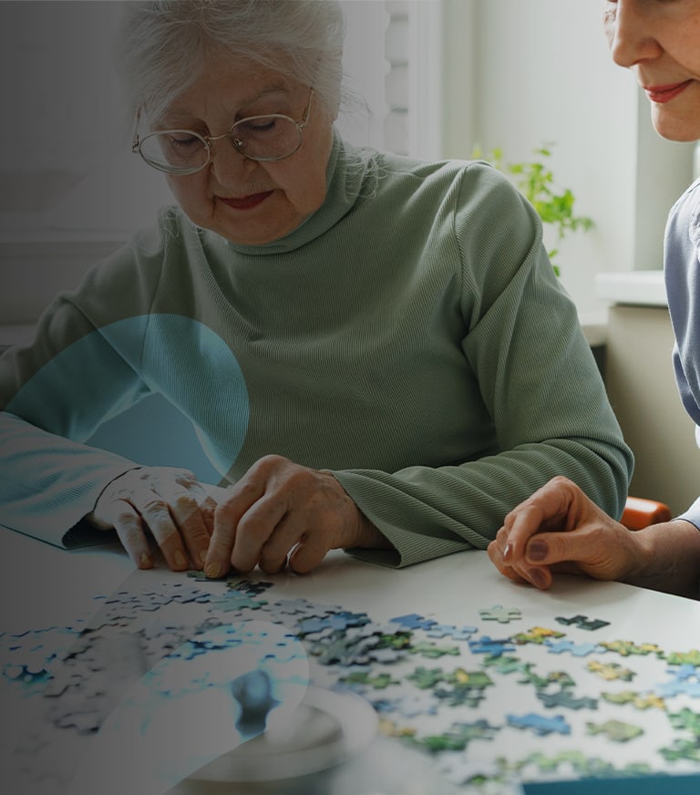 Residents working on a puzzle together.