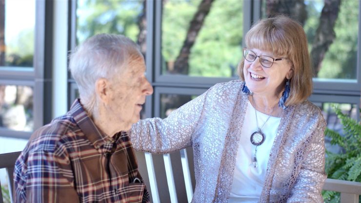 Resident and staff member enjoying a conversation.