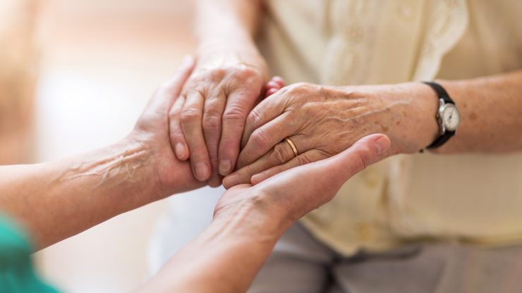 Two hands together showcasing care and support.