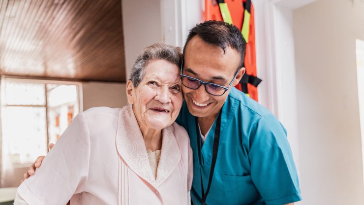 Staff member and resident smiling together