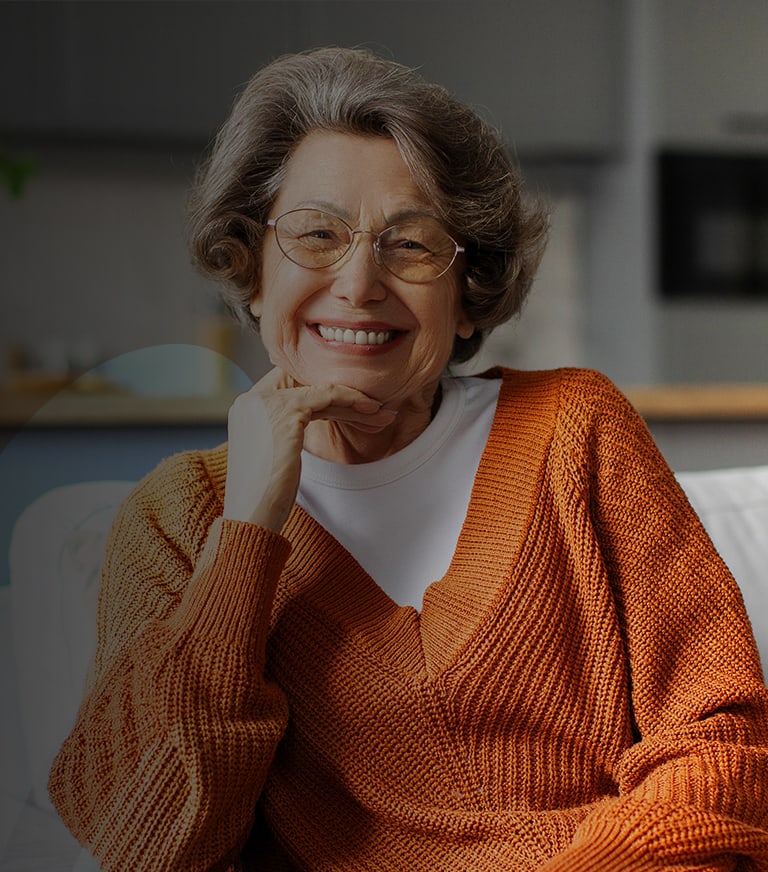 Smiling elderly woman in a cozy sweater