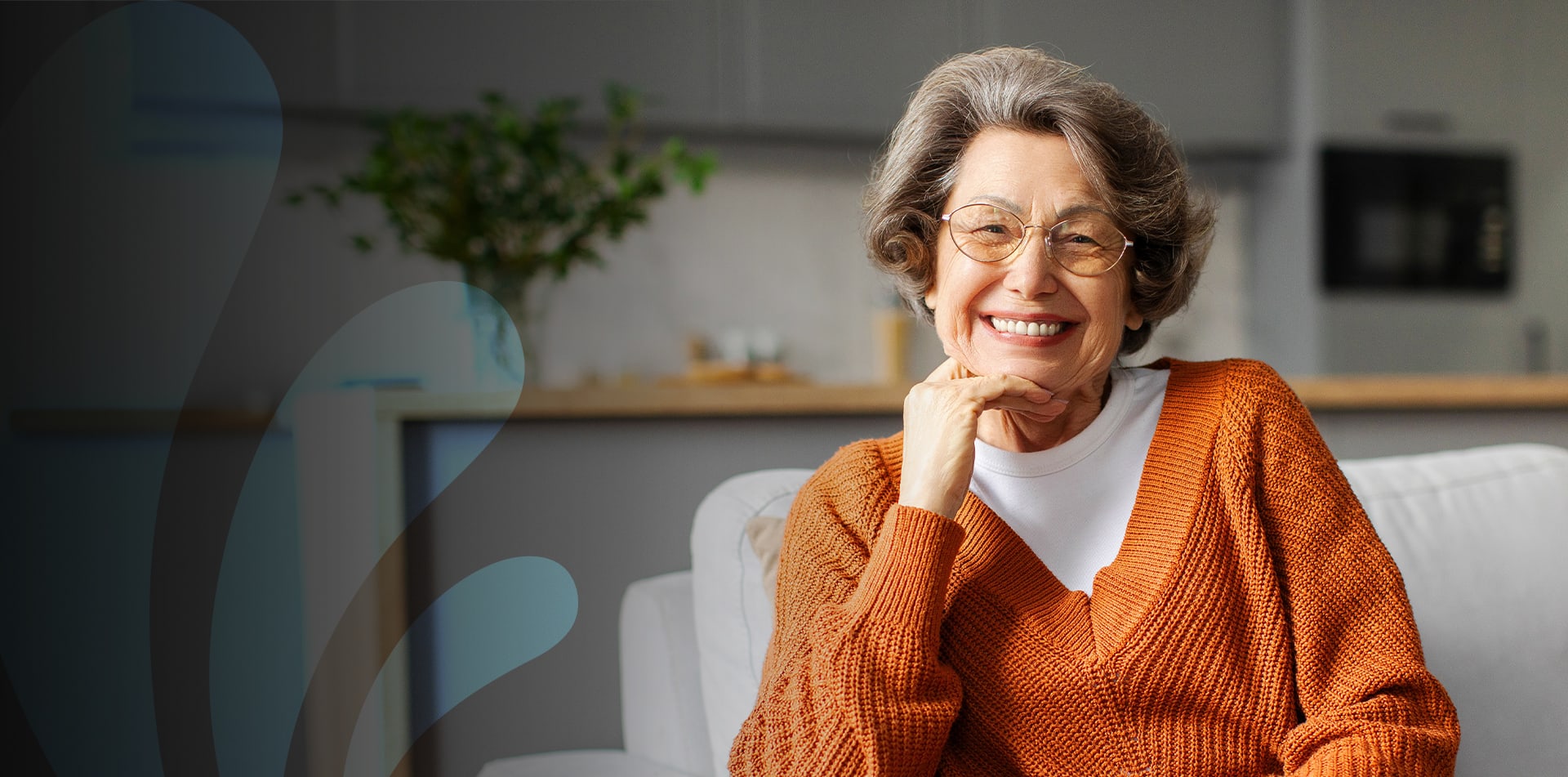 Smiling elderly woman in a cozy living space.