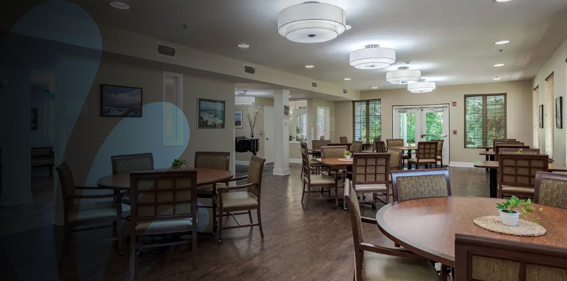 Bright common area with dining tables and chairs.