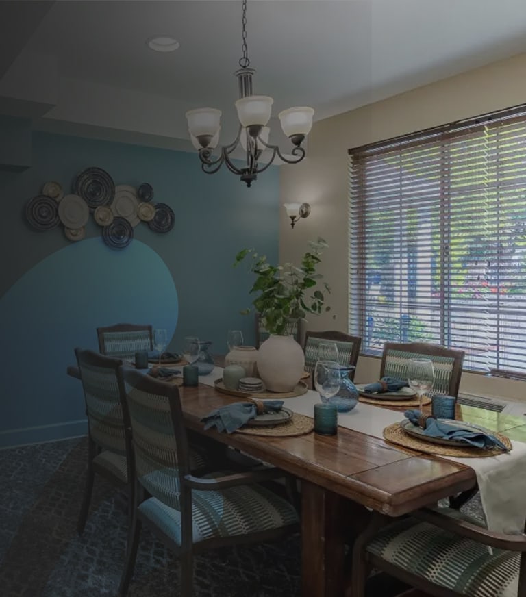 Elegant dining room setup with table and chandelier.