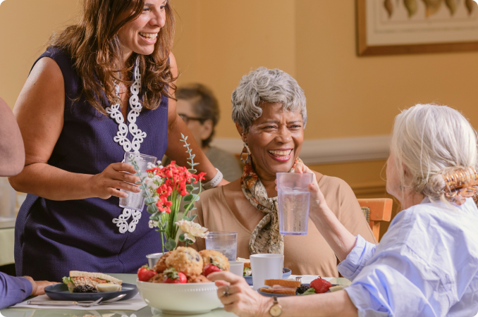 Residents enjoying a meal together in the dining room