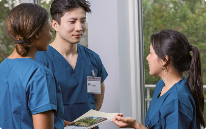 Three staff members engaging in conversation