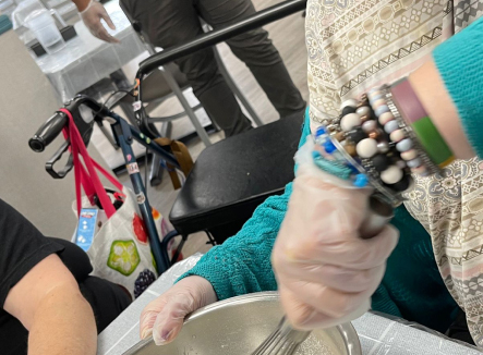 Resident participating in an activity with food preparation.