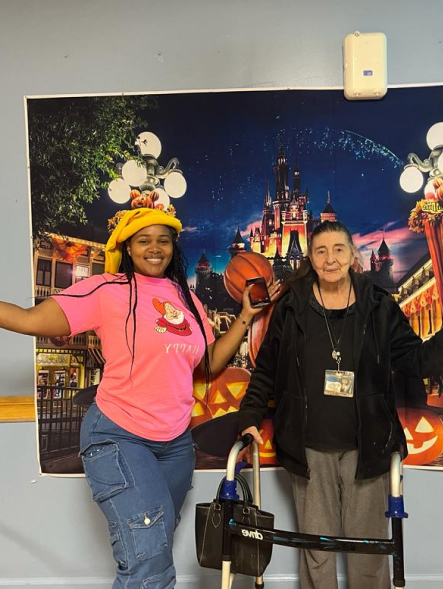 Resident and staff member celebrating during an event