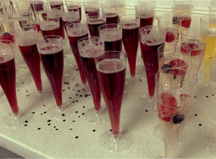 Champagne glasses filled with drinks and berries