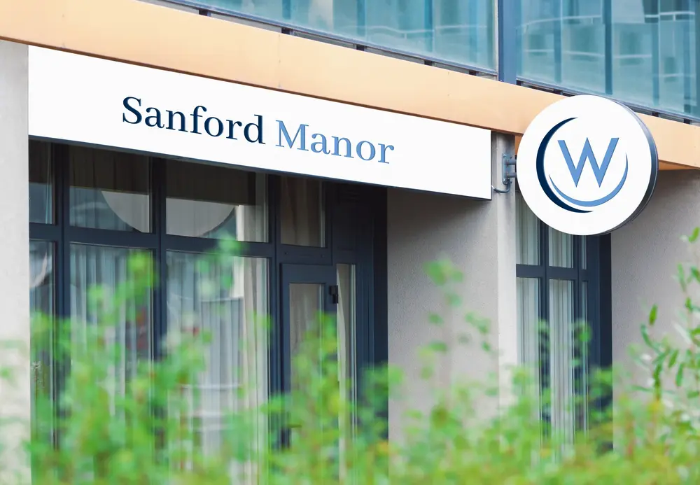 Exterior signage of Sanford Manor with logo