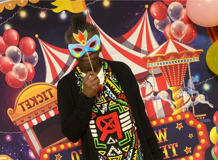 Resident enjoying a festive event with a mask