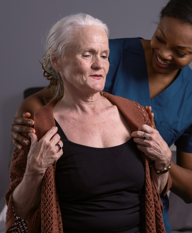 Caregiver assisting a senior resident indoors.