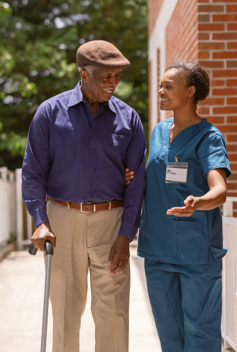 A resident and staff member engaging outdoors.